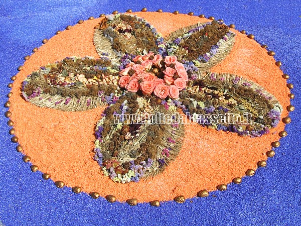 BRUGNATO (Infiorata del Corpus Domini 2011) - Disegno circolare composto da roselline, fiori secchi, sabbia e sassolini colorati