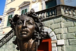 Scultura monumentale dal volto umano posta di fronte a Palazzo Moroni