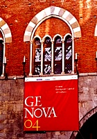 GENOVA - Una finestra dell'avancorpo medievale di Palazzo San Giorgio espone un drappo col logo di "Genova 2004 - Capitale Europea della Cultura"
